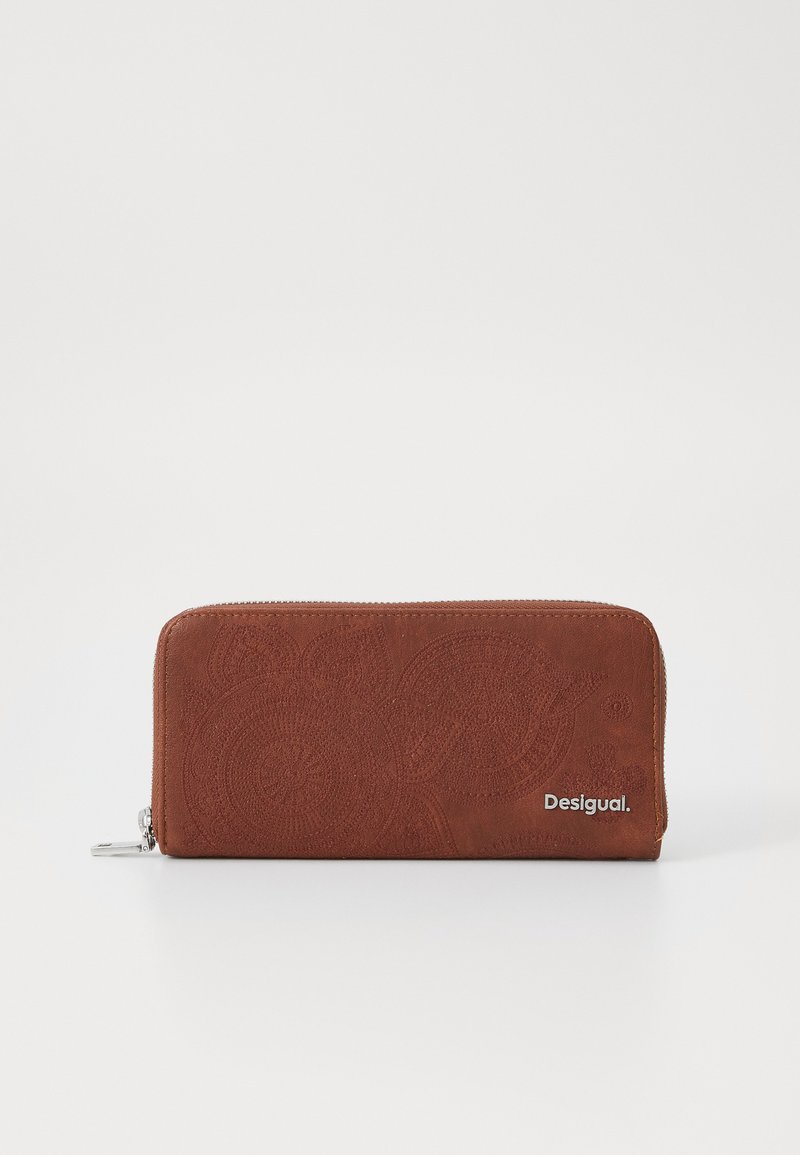 Brown suede wallet with embossed circular patterns, zip closure, and silver hardware. Features a logo on the bottom right corner.
