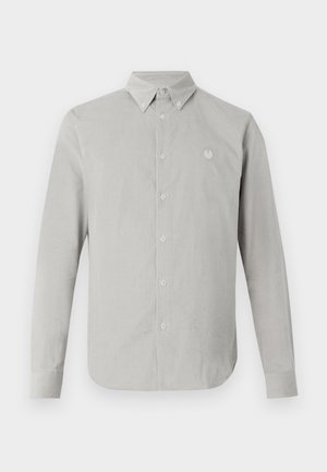 Light gray long-sleeve shirt with a button-down collar, featuring a subtle texture and a small embroidered emblem on the left chest.