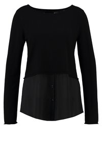 Svart tröja med långa ärmar, med en lager-på-lager-design; stickad överdel med skjortliknande underdel, knappstängning och slät yta.