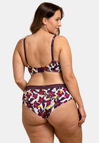 Ensemble de lingerie composé d'un soutien-gorge et d'un slip à imprimé floral, avec une base blanche, des bretelles violettes et des accents en dentelle, mettant en avant des fleurs roses vives et jaunes.