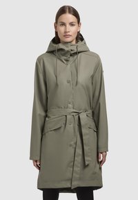 Olive green raincoat, lightweight, with a cinched waist, hood, snap buttons, and side pockets. Smooth texture with an adjustable drawstring.