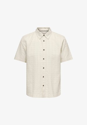 Chemise crème à manches courtes avec col à revers et six boutons noirs à l'avant, présentant un motif quadrillé texturé subtil.
