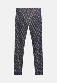 Leggings in tessuto blu navy scuro caratterizzati da un motivo geometrico ripetuto in tonalità più chiare. Design aderente con una texture liscia e senza hardware visibile.