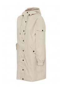 Beige Kapuzenregenmantel aus leichtem Material. Mit Druckknöpfen, elastischen Bündchen und seitlichen Taschen mit Klappen.