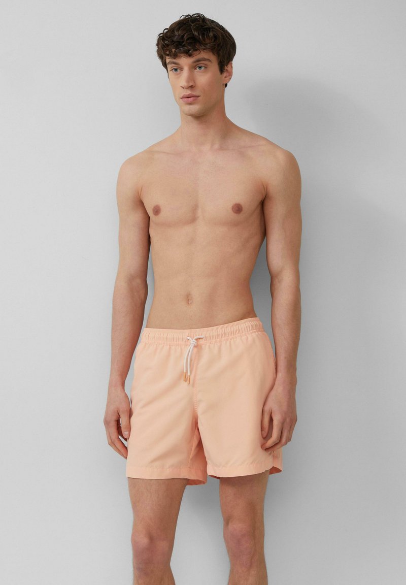 Pantaloni da bagno pesca realizzati in tessuto leggero, dotati di una cintura elastica con cordino e un design semplice e monocolore.