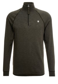 Ciemnozielona bluza z półzamkiem, wykonana z teksturowanej tkaniny, z długimi rękawami i stojącym kołnierzem. Na piersi znajduje się małe logo.