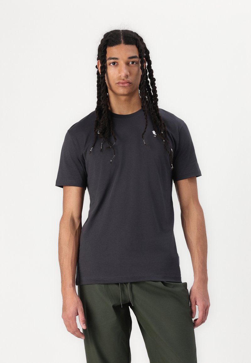 Dark gray crew neck t-shirt made of soft fabric with short sleeves; features a minimalistic logo on the left chest.