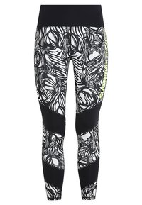 Leggings in bianco e nero con un design floreale, caratterizzati da una vita nera solida e pannelli in rete nera texturizzata lungo i lati.