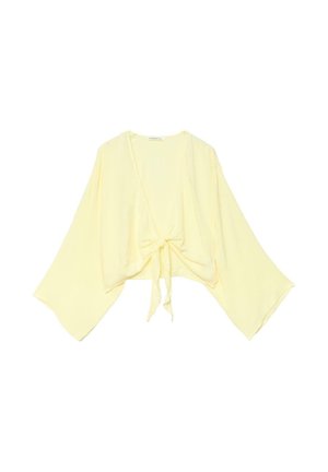 Cardigan ample jaune clair avec larges manches style kimono et fermeture à nœud sur le devant.