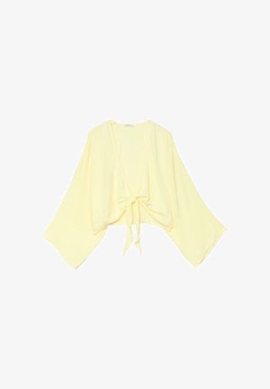 Cardigan ample jaune clair avec larges manches style kimono et fermeture à nœud sur le devant.