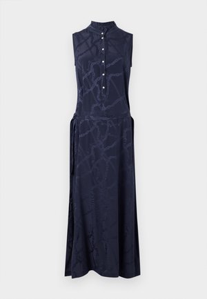 Marineblaues ärmelloses Kleid mit hohem Kragen, Knopfleiste und subtilm Kettenmuster. Der weiche Stoff und die Seitenschnürung schaffen eine fließende Silhouette.