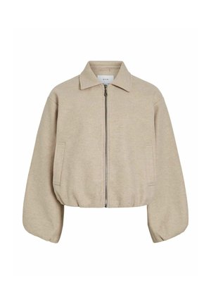 Veste beige taillée avec fermeture éclair sur le devant, col pointu et poches latérales. Texture douce et manches bouffantes amples.