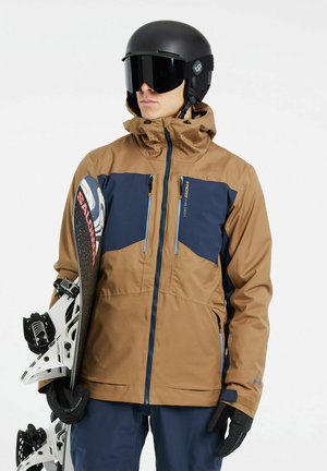 Chaqueta de esquí marrón y azul marino con capucha, dos bolsillos con cremallera y cremalleras azules. Guantes negros y una tabla de snowboarding con fijaciones blancas completan el conjunto.