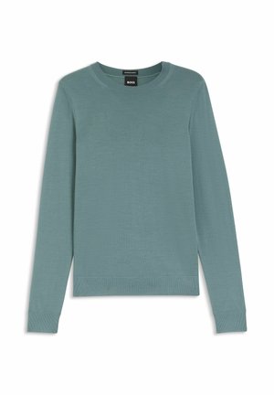 Ljus teal långärmad tröja gjord av mjukt, slätt tyg. Har rund halsringning och ribbade muddar och fåll. Enkel, minimalistisk design.