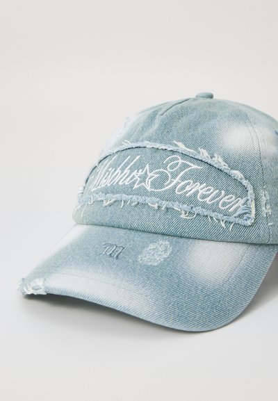 Denim baseball cap in light blue with distressed accents, featuring “Forever” embroidered on the front. Curved visor and adjustable strap.