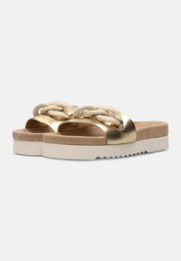 Gold metallic slide sandals with a textured beige strap and decorative chain link detail, featuring a thick white platform sole.