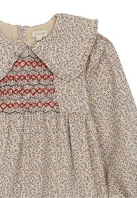 Sukienka w kwiatowy wzór z jasnobeżowej bawełny, z dużym kołnierzem, czerwonymi haftowanymi akcentami i marszczoną spódnicą dodającą objętości.