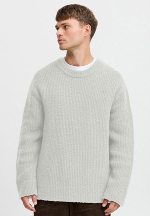 Light gray ribbed sweater with a crew neckline and long sleeves. Features a relaxed fit and a textured knit pattern.