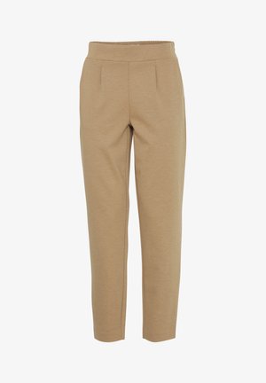 Beige housut, jotka on kapenevat alhaalta, valmistettu pehmeästä ja teksturoituneesta kankaasta. Niissä on leveä, joustava vyötärö ja kaksi etupuolelle ommeltua laskosta. Suora lahkeiden muoto.