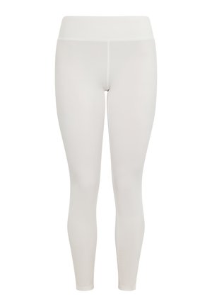 Bele legice iz narejen iz raztegljivega, gladkega materiala z visokim pasom in oprijetim krojem, ki vključuje brezšivno obdelavo.