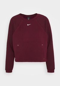 Top sportivo a maniche lunghe Nike Pro color bordeaux con maniche trapuntate, colletto a giro e logo Nike bianco centrato sul petto.