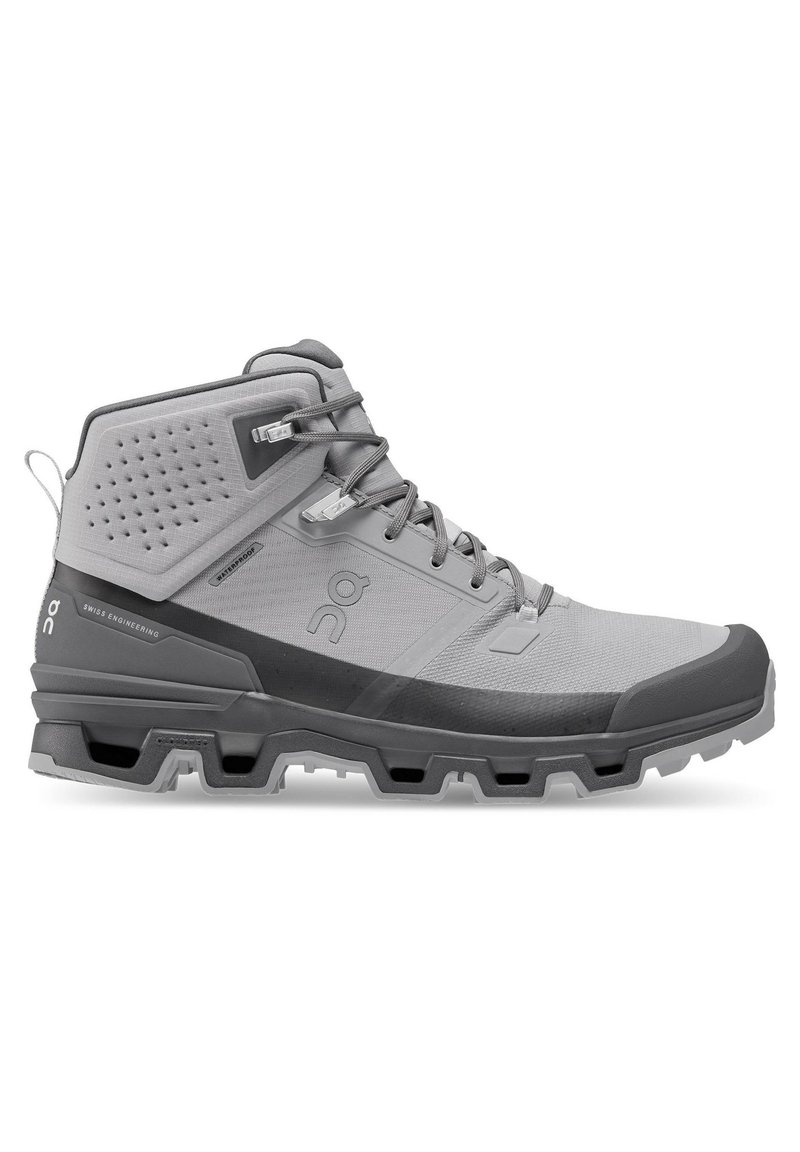 Mid-cut hiking shoe in light gray and dark gray. Features textured synthetic upper, reinforced toe cap, and rubber sole with multi-directional lugs.