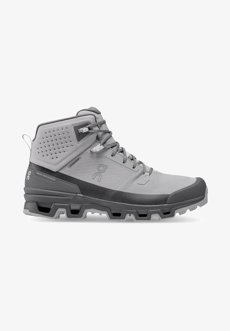 Mid-cut hiking shoe in light gray and dark gray. Features textured synthetic upper, reinforced toe cap, and rubber sole with multi-directional lugs.