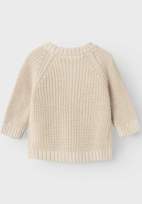 Strickpullover in Beige mit strukturiertem Muster, Raglanärmeln, breiten gerippten Bündchen und rundem Halsausschnitt. Hat eine lockere, kastige Form.