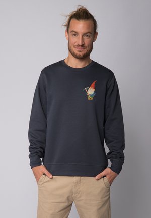 Navy sweatshirt with long sleeves, crew neck, and a gnome graphic on the left chest. Cotton blend material with ribbed cuffs.