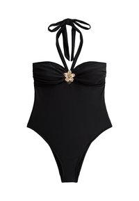Maillot de bain noir une pièce avec un lien derrière le cou, fronces au niveau de la poitrine et un accent en forme de fleur dorée au centre. Texture lisse et couverture intégrale.