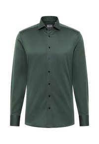 Camicia a maniche lunghe verde scuro in tessuto strutturato, con chiusura a bottoni sul davanti, bottoni neri e colletto classico. Presenta polsini sartoriali.