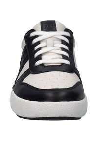 Black and white leather sneakers with perforated details and white laces. Round toe, cushioned white rubber sole, and branding on the tongue.