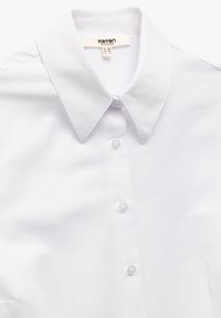 Camicia bianca con colletto realizzata in un morbido tessuto misto cotone. Presenta una chiusura frontale con bottoni bianchi e un design pulito.