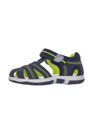 Navy blue sandal with green accents, breathable material, multiple straps, Velcro closure, and white sole; rugged tread pattern.