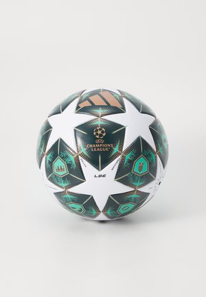 White soccer ball with green and black star panels, featuring the UEFA Champions League logo and a textured surface, made of synthetic material.