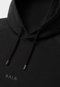 Black hoodie featuring a drawstring with metallic tips and embroidered "BALR." logo on the front, made of soft, textured fabric.