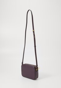 Purple leather crossbody bag with a rectangular shape, zipper closure, and adjustable strap. Features gold-tone hardware accents.