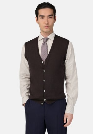 Chaleco de punto marrón con escote en V, cierre de seis botones y textura sutil, usado sobre una camisa de vestir a rayas y combinado con una corbata a rayas.