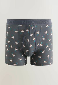 Tummanharmaat miesten bokserit, joissa on toistuva kuvio pienistä, värikkäistä sinisorsista ja leveä vyötärönauha, jossa lukee "NEXT".