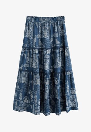 Modrá vrstvená sukňa s elastickým pásom, ozdobená zložitými bielymi vzormi a bodkami. Bavlnená látka s plynulou textúrou.