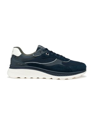 Navy blue athletic shoe with mesh and suede materials, featuring a thick white outsole and grey accents, laces, and ventilation holes.