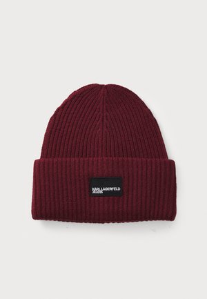 Burgundy knit beanie with ribbed texture, featuring a black rectangular label with "KARL LAGERFELD JEANS" in white text on the front.