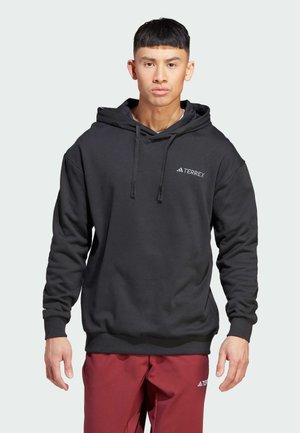 Sudadera con capucha negra y cordones, que presenta un pequeño logo blanco de TERREX. Fabricada con un tejido suave y cuenta con puños y dobladillo acanalados.