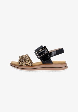 Comfort sandal with leopard print front strap, black patent ankle strap with large rectangular buckle, padded tan footbed, and white sole.