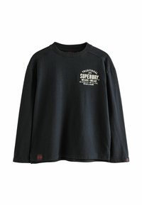 Sweatshirt negru cu mâneci lungi și guler rotund, având un logo brodat în crem pe piept și o mică etichetă cu logo la margine.
