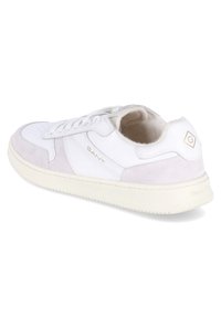 Weiße Ledersneaker mit pinken Wildledereinlagen, Schnürdesign, runde Zehenpartie und goldfarbene Logo-Akzente an der Seite und Ferse. Gummisohle.