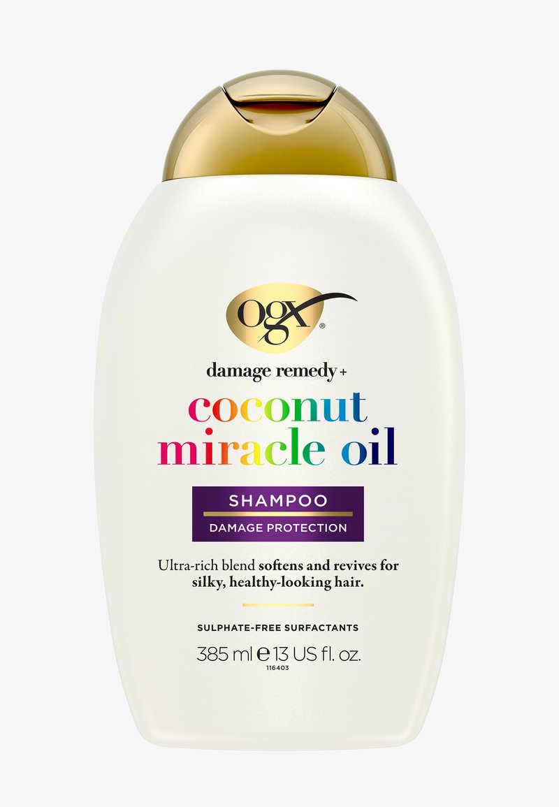 Flacon de shampooing OGX Damage Remedy Coconut Miracle Oil avec bouchon doré, 385 ml, pour la protection contre les dommages et des cheveux soyeux et en bonne santé.