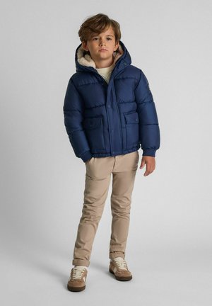 Navy puffer jacket with a hood, featuring a soft, beige fleece lining, two front pockets, and a smooth, shiny outer material.