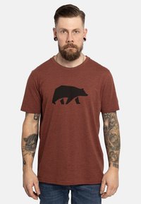 Camiseta de manga corta marrón de brezo con un gráfico de un oso negro centrado en la parte delantera. Cuello redondo y corte relajado.