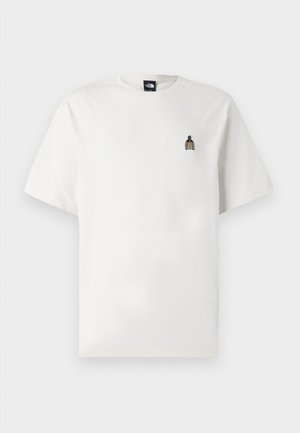 T-shirt in cotone bianco con una piccola grafica ricamata di una bottiglia sul lato sinistro del petto. Collo rotondo classico e maniche corte.